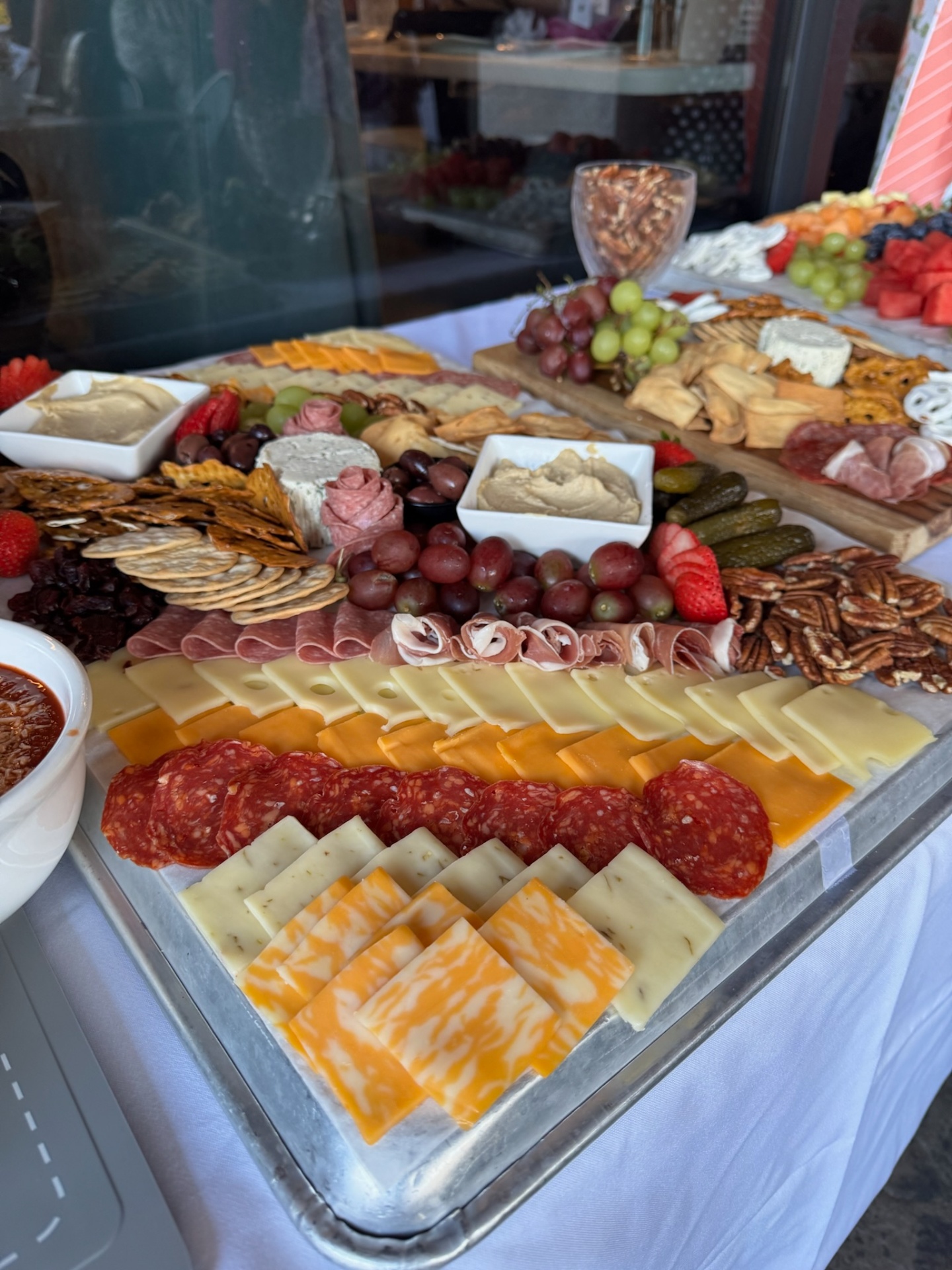 Grand charcuterie board with cheeses, salami and pecans